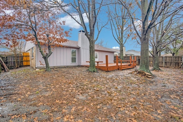 rear view of property featuring a wooden deck