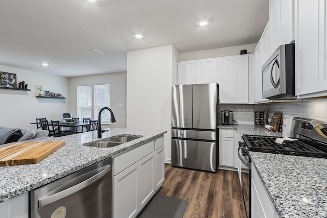 kitchen featuring stainless steel appliances, sink, and white cabinets