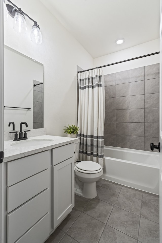 full bathroom with vanity, tile patterned floors, toilet, and shower / bath combo with shower curtain