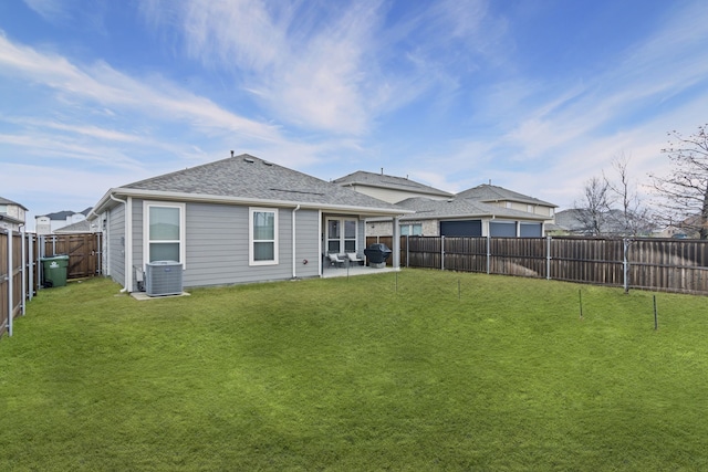 rear view of property featuring a patio, a yard, and central AC unit