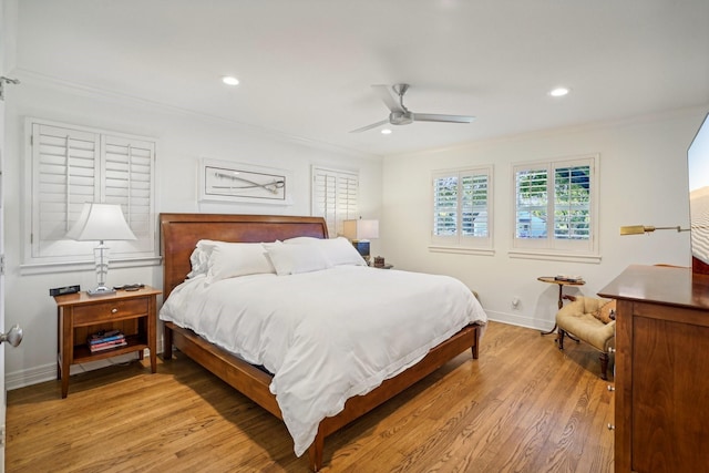 bedroom featuring ornamental molding, ceiling fan, and light wood-type flooring