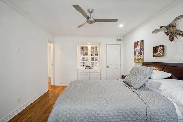 bedroom featuring hardwood / wood-style flooring, ceiling fan, and ornamental molding