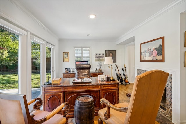 office with ornamental molding and light hardwood / wood-style floors