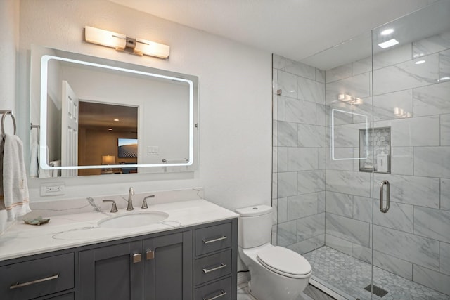 bathroom with vanity, toilet, and walk in shower