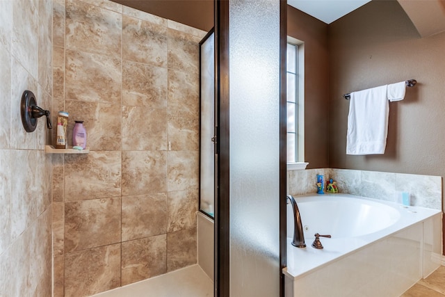 bathroom with separate shower and tub