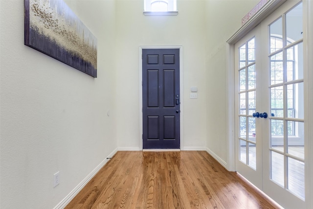 foyer featuring light wood-type flooring and french doors