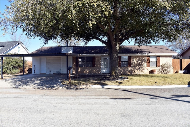 ranch-style house featuring a carport