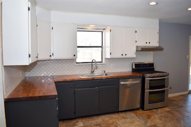 kitchen featuring butcher block countertops, sink, stainless steel appliances, tasteful backsplash, and white cabinets