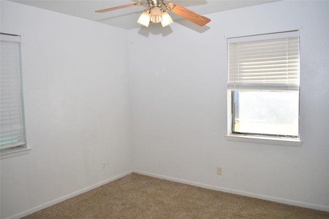 carpeted spare room featuring ceiling fan