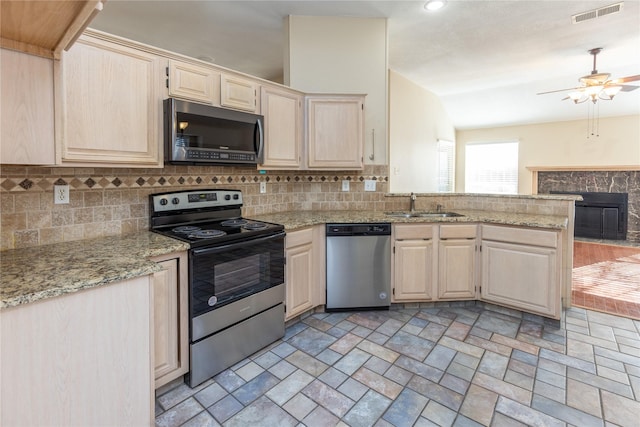 kitchen with visible vents, light brown cabinetry, decorative backsplash, appliances with stainless steel finishes, and a sink