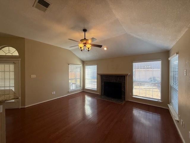 unfurnished living room with lofted ceiling, a premium fireplace, ceiling fan, dark hardwood / wood-style floors, and a textured ceiling