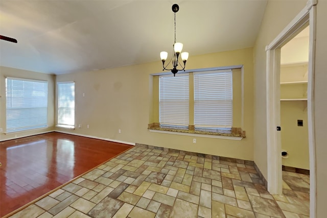 unfurnished dining area with an inviting chandelier