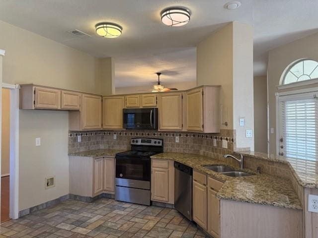 kitchen with sink, backsplash, stainless steel appliances, light stone countertops, and light brown cabinetry