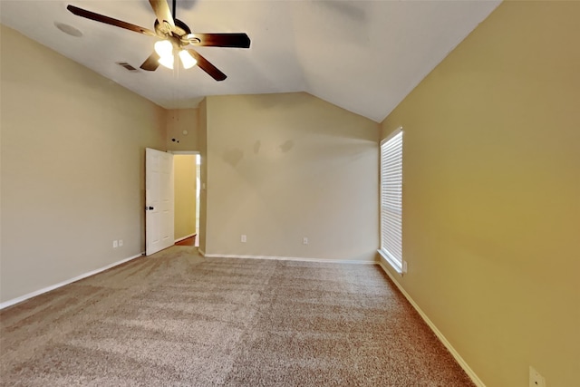 empty room featuring lofted ceiling, carpet flooring, and ceiling fan