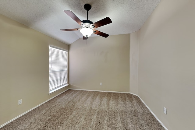 carpeted spare room with a ceiling fan, baseboards, and a textured ceiling