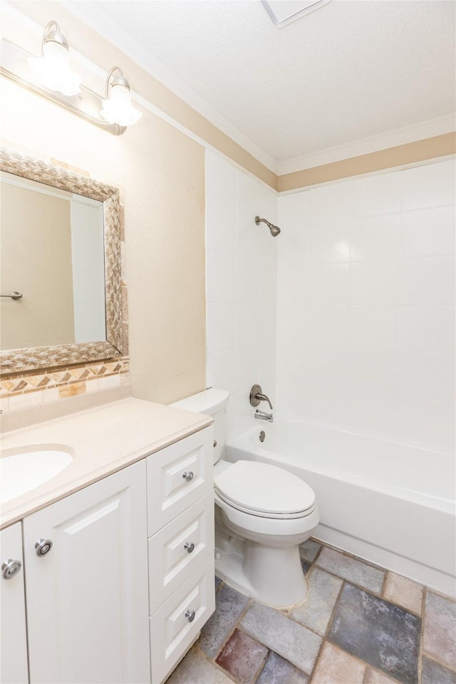 full bathroom featuring toilet, stone finish flooring, shower / washtub combination, crown molding, and vanity