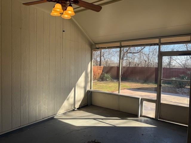 unfurnished sunroom featuring ceiling fan and lofted ceiling