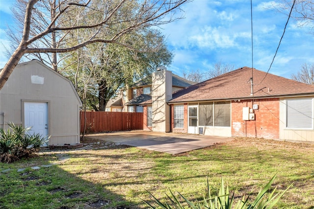 view of yard featuring an outdoor structure, a patio, and fence