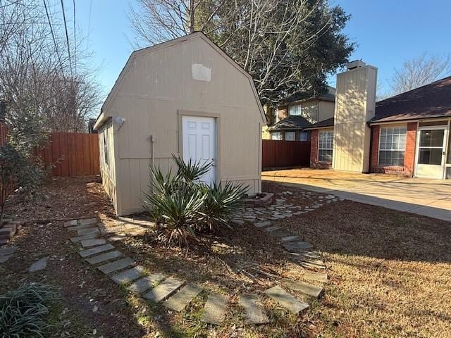 view of outbuilding with an outbuilding and fence