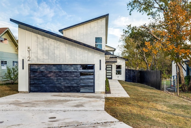 view of front of house with a garage and a front lawn