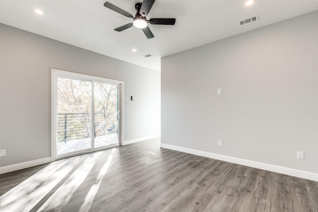 empty room featuring ceiling fan and dark hardwood / wood-style flooring