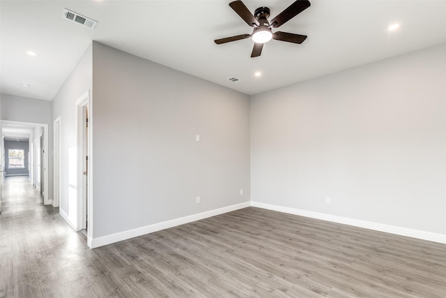 unfurnished room with ceiling fan and light wood-type flooring