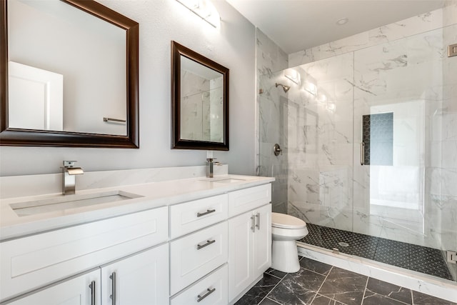 bathroom with vanity, a shower with door, and toilet