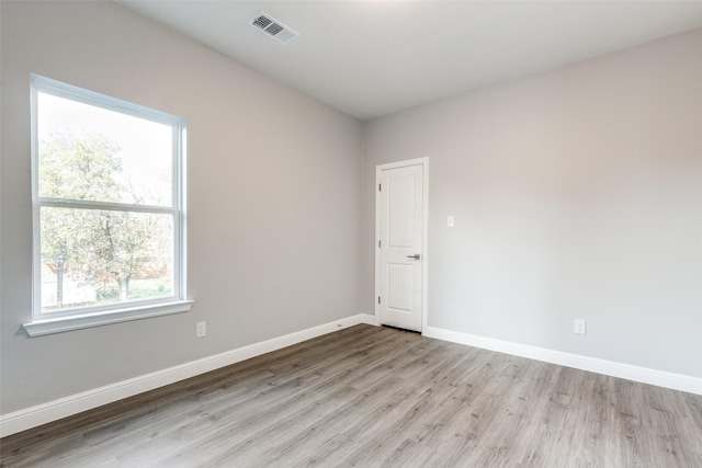 unfurnished room with light wood-type flooring