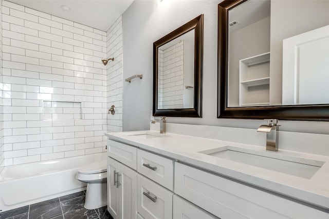 full bathroom featuring tiled shower / bath combo, vanity, and toilet