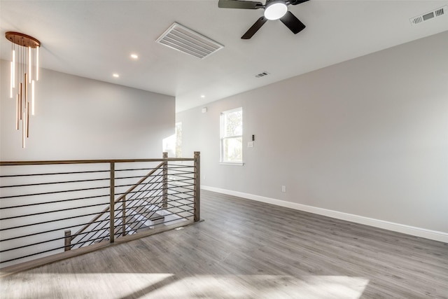 spare room featuring wood-type flooring and ceiling fan