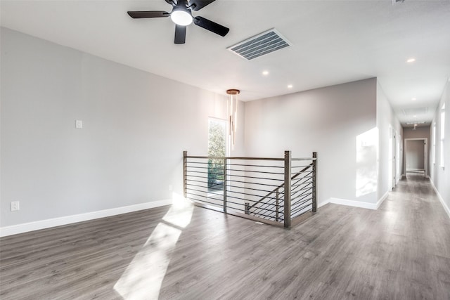 unfurnished room with hardwood / wood-style flooring and ceiling fan