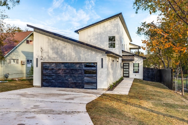 view of front facade with a garage and a front lawn