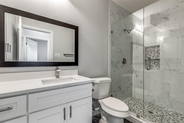 bathroom with vanity, toilet, and an enclosed shower