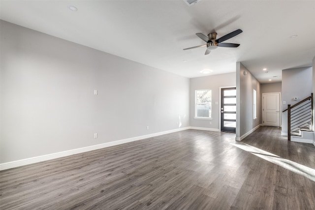 unfurnished living room with dark hardwood / wood-style floors and ceiling fan