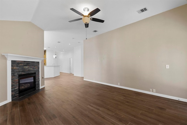 unfurnished living room with a fireplace, dark hardwood / wood-style floors, and ceiling fan