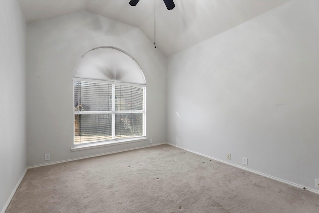 carpeted spare room featuring ceiling fan and lofted ceiling