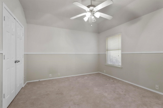 carpeted spare room with ceiling fan