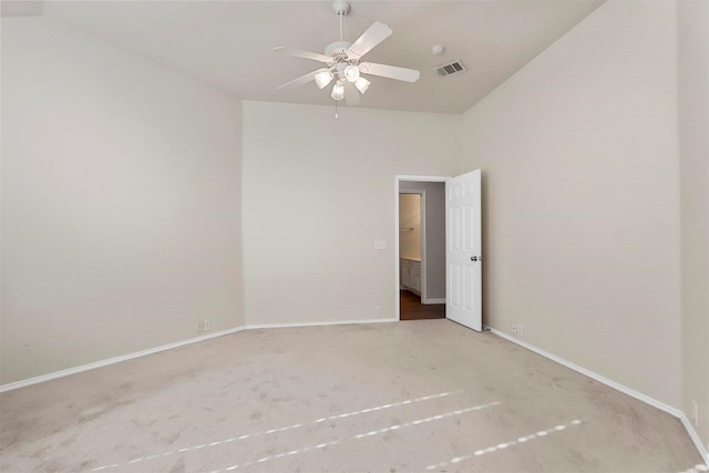 carpeted spare room with lofted ceiling and ceiling fan