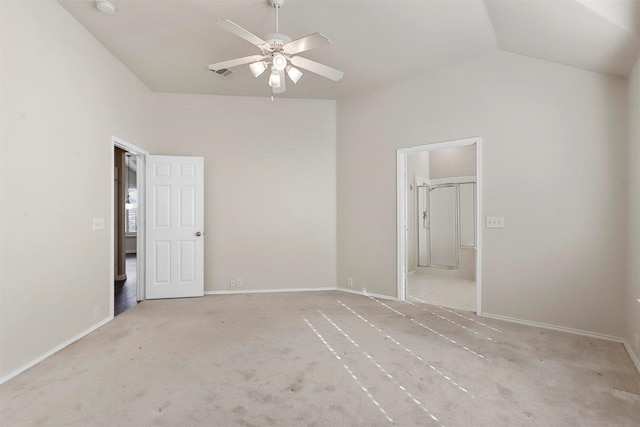 unfurnished bedroom with ceiling fan, ensuite bath, lofted ceiling, and light colored carpet