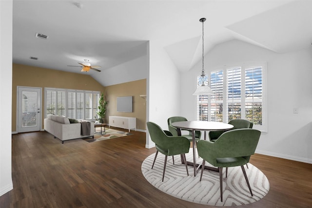 dining area with ceiling fan, lofted ceiling, and dark hardwood / wood-style floors