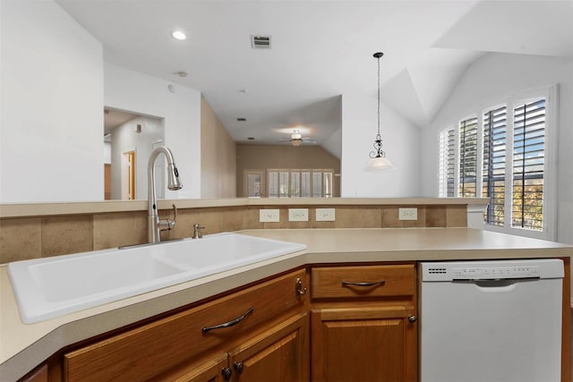 kitchen with pendant lighting, dishwasher, lofted ceiling, sink, and ceiling fan