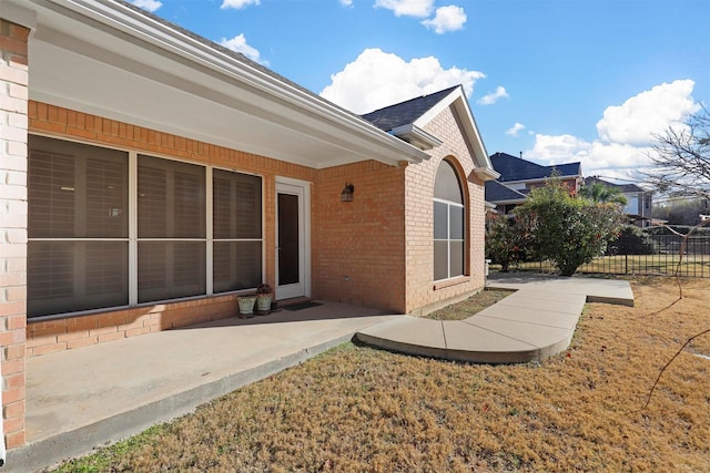 back of property with a yard and a patio area