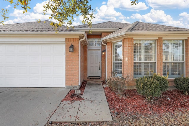 view of exterior entry with a garage