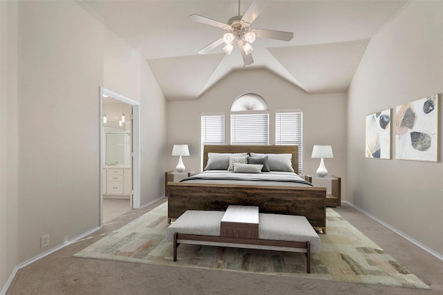 carpeted bedroom featuring lofted ceiling, connected bathroom, and ceiling fan