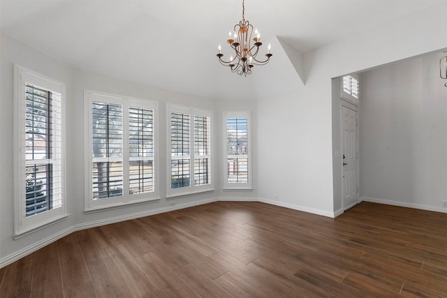 unfurnished dining area featuring dark hardwood / wood-style floors and a chandelier