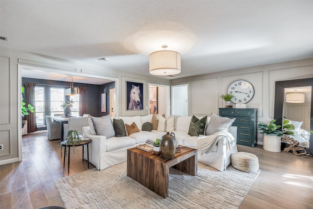 living room with hardwood / wood-style flooring and a textured ceiling