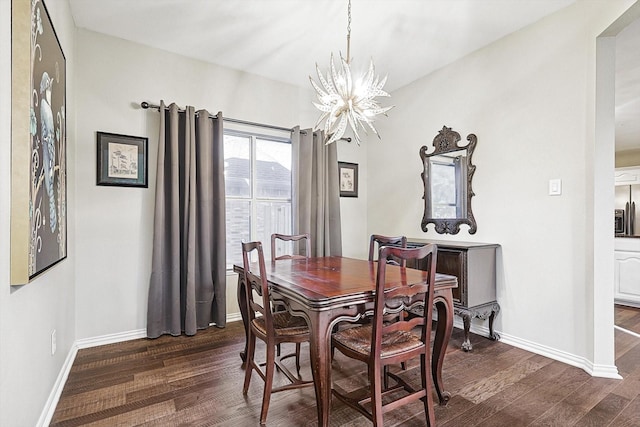 dining room featuring a notable chandelier and dark hardwood / wood-style flooring