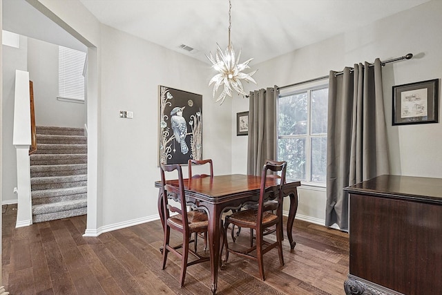 dining area featuring an inviting chandelier and dark hardwood / wood-style floors