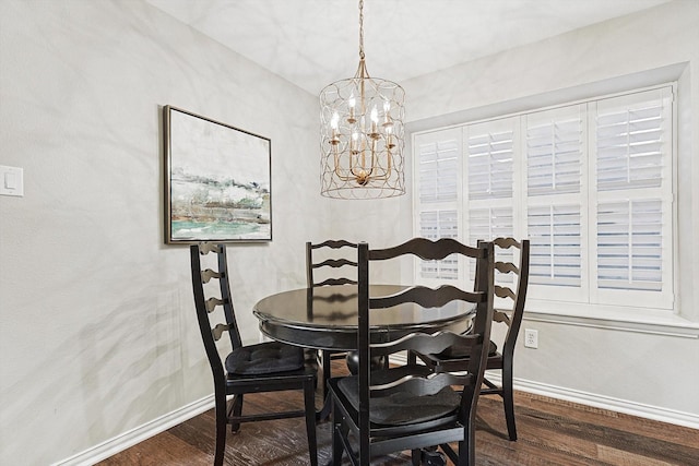 dining room featuring dark hardwood / wood-style flooring and a notable chandelier