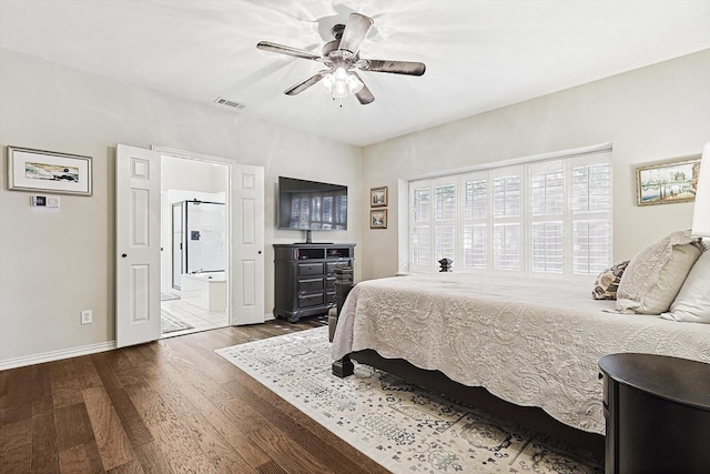 bedroom featuring hardwood / wood-style flooring, ensuite bath, and ceiling fan